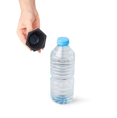 Person holding bottle opener near bottle