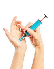 The Genteel Lancing Device in use on the palm of a hand