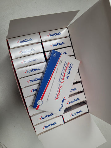 Open box of individual rapid antigen tests